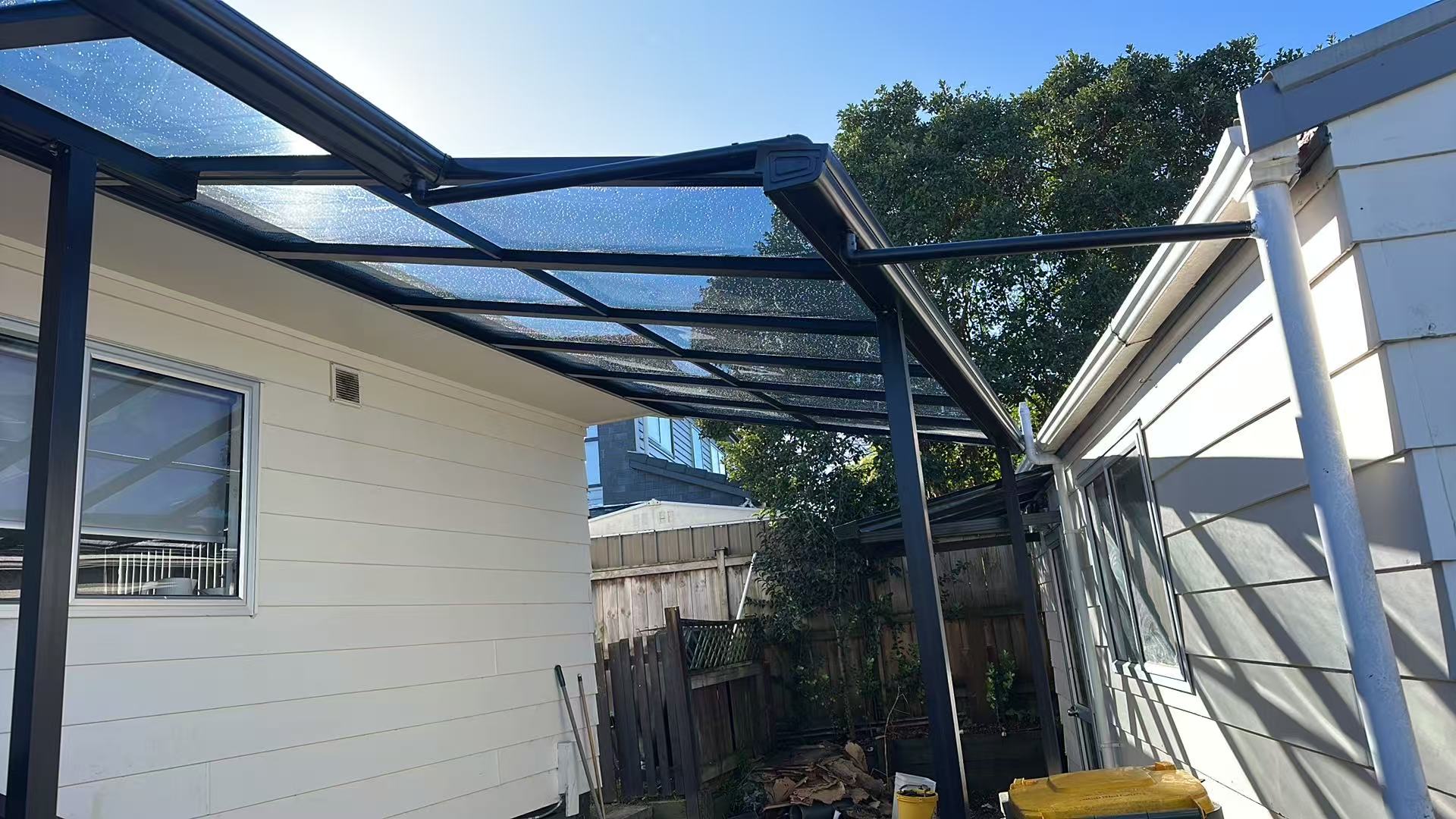 Custom covered link canopy connecting two Auckland buildings