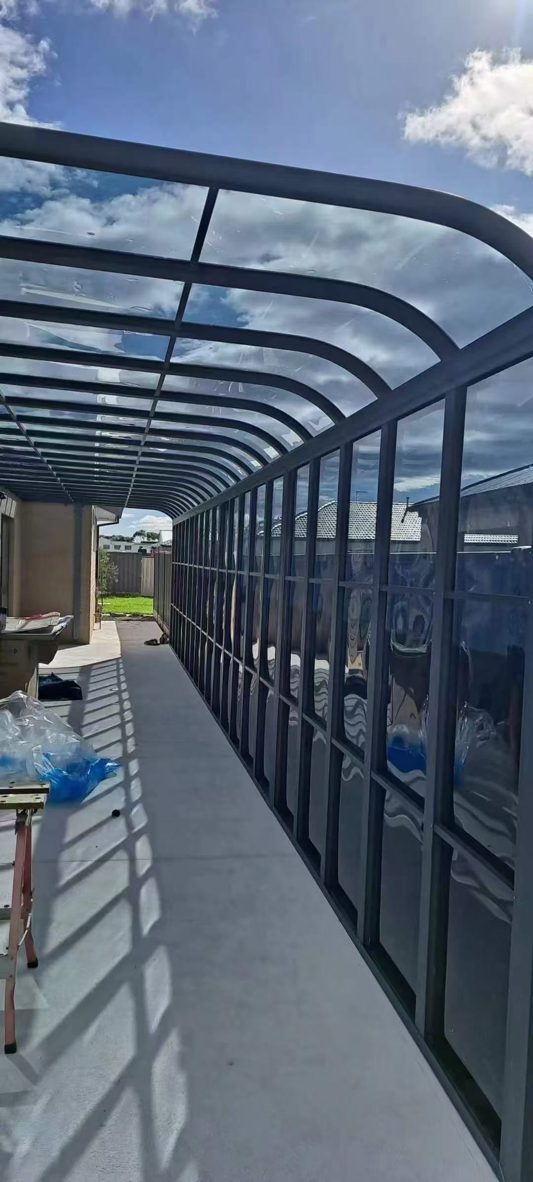 Curved polycarbonate roof walkway enclosure built in Auckland