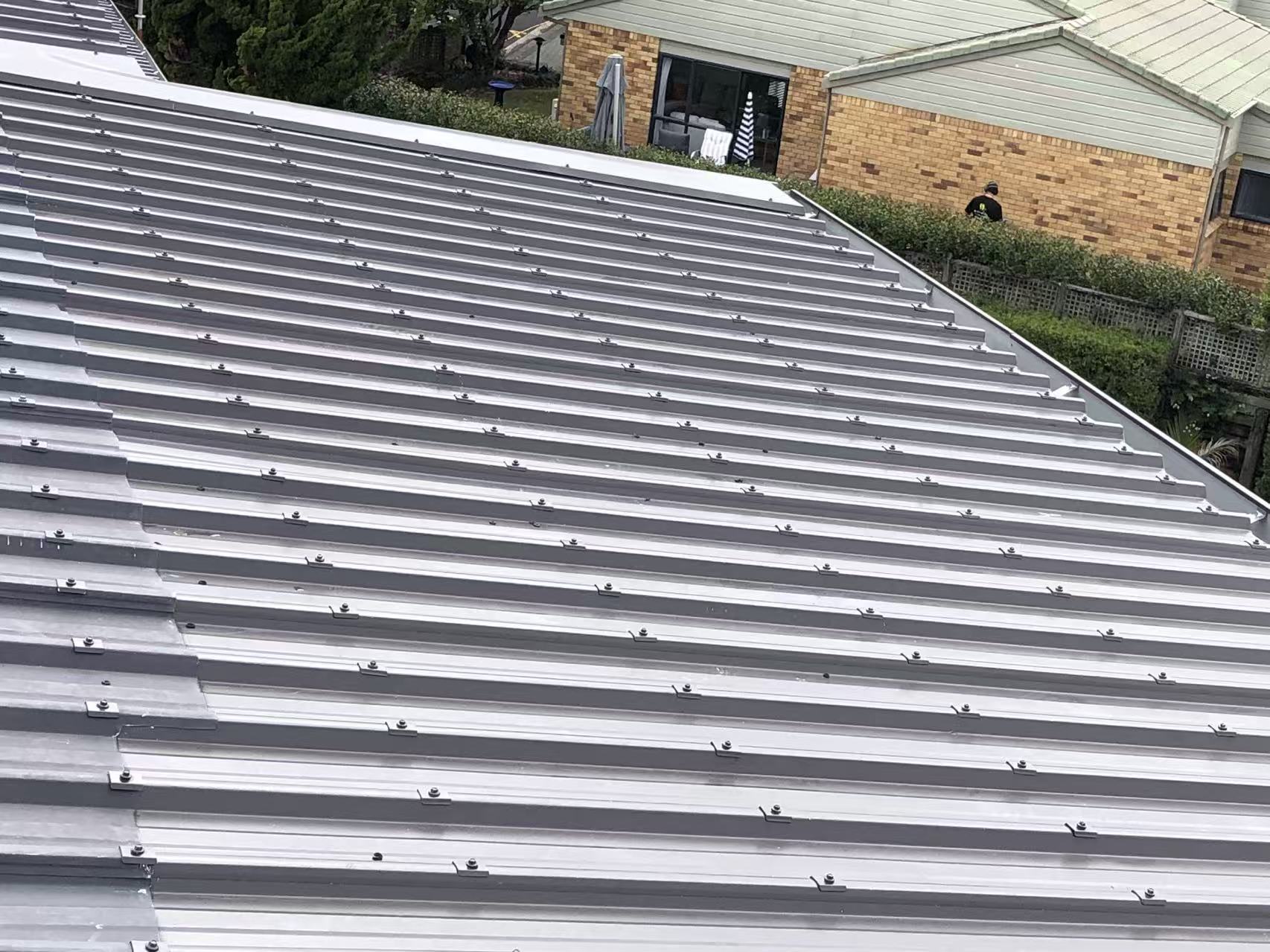Silver-grey longrun metal roof after re-roofing in Auckland