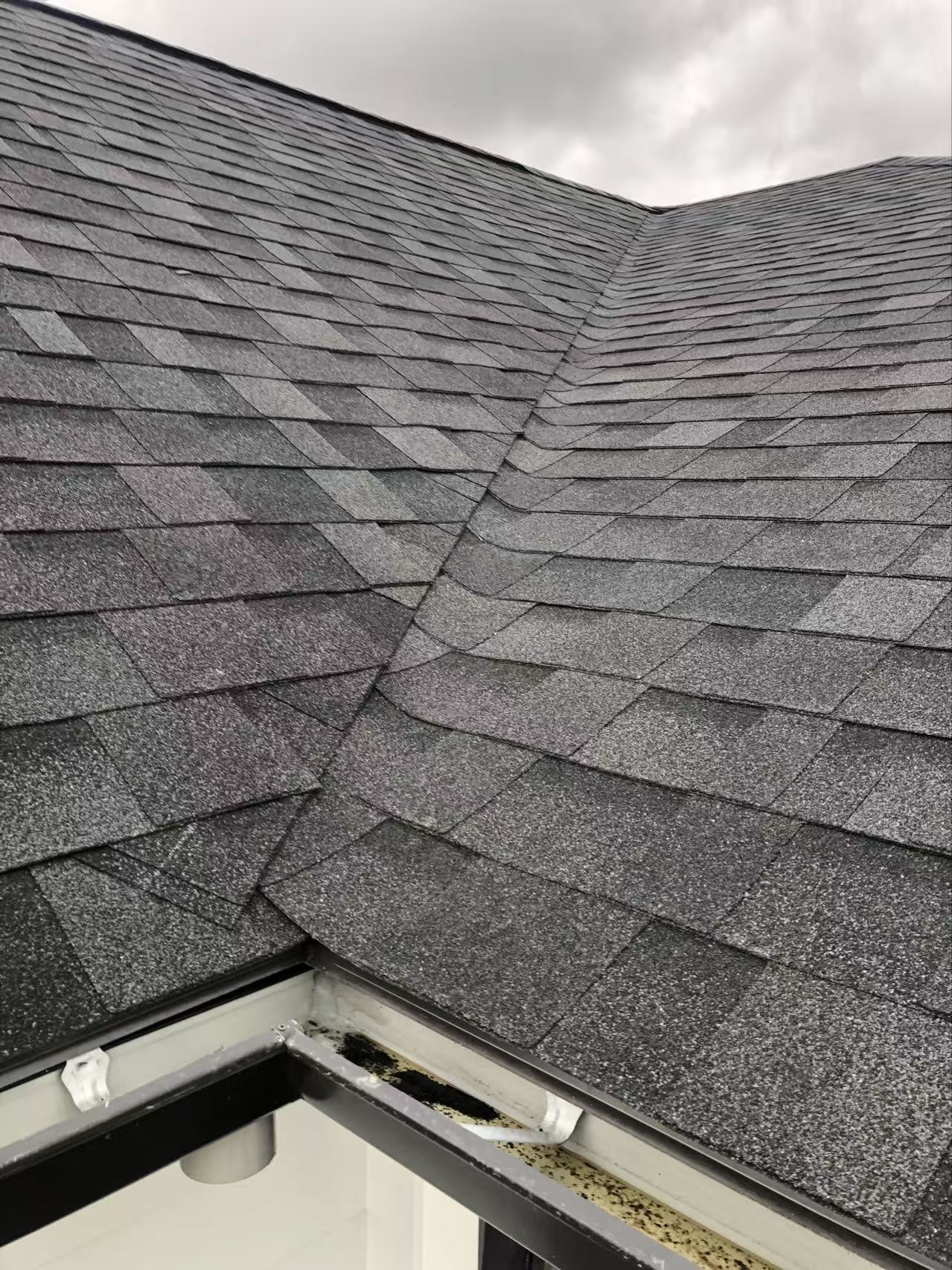 Asphalt shingle roof installation with finished valley detail
